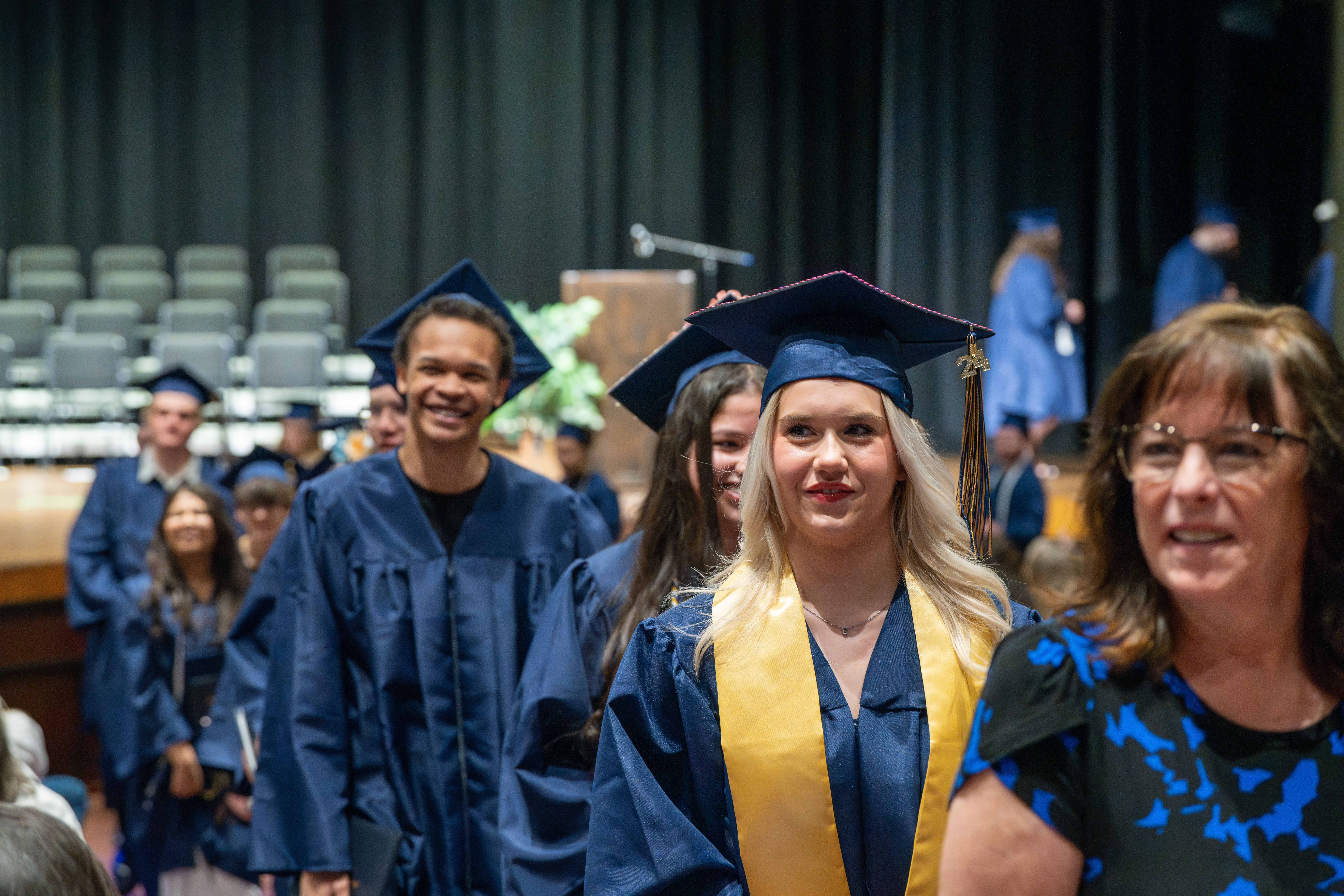 Poudre Global Academy graduates file in.