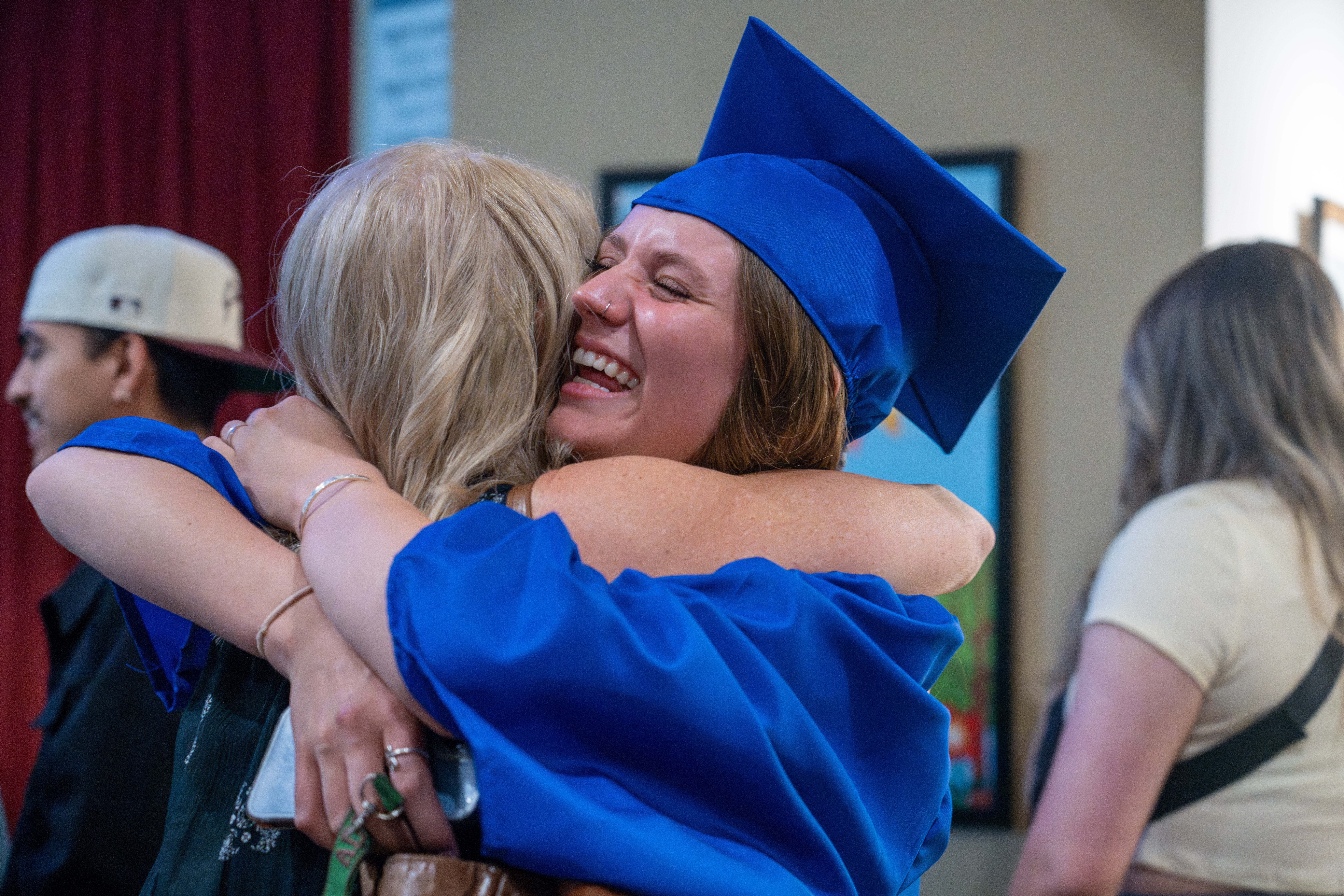Poudre High School IB grad hugs a family member.