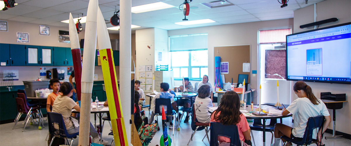 A middle school STEM class in action making things.