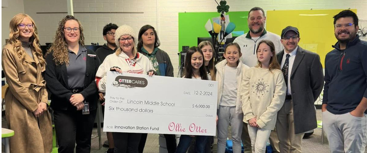 OtterCares presents a check to Lincoln Middle School for their grant award.