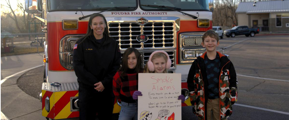 Fire preventiion poster winners in front of a fire truck. 