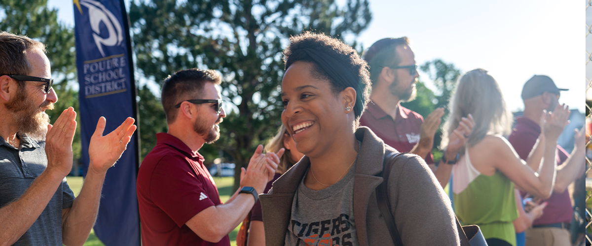 A teacher smiling at others.