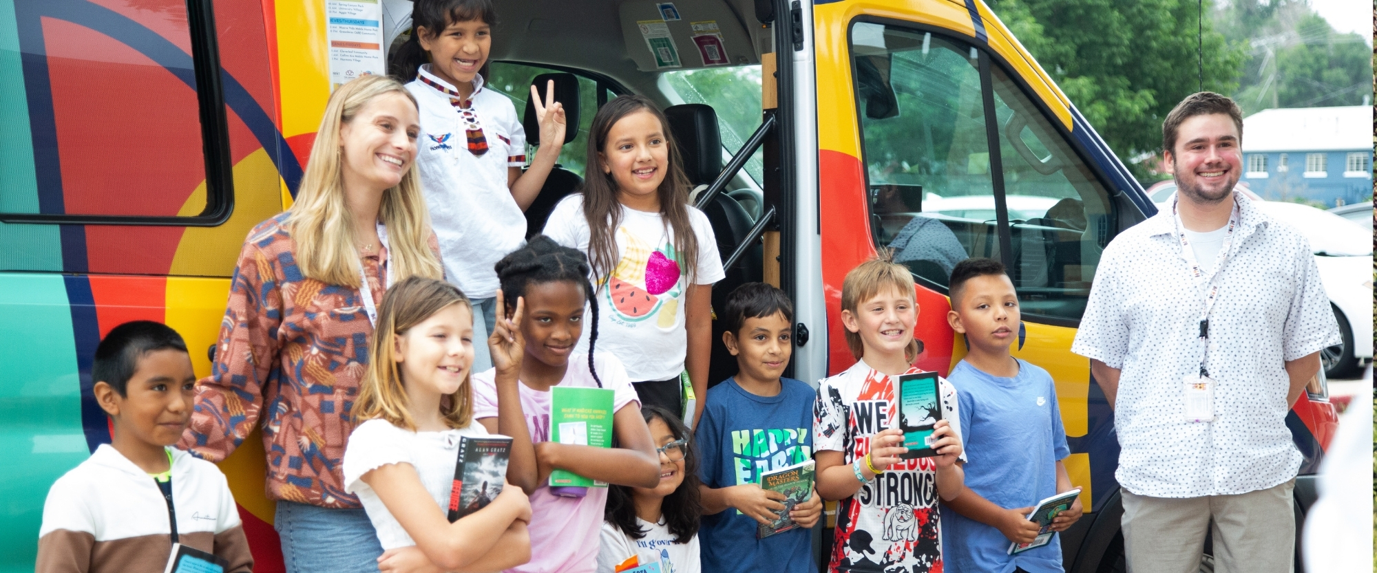 Students and instructors smiling in front of the mobile library