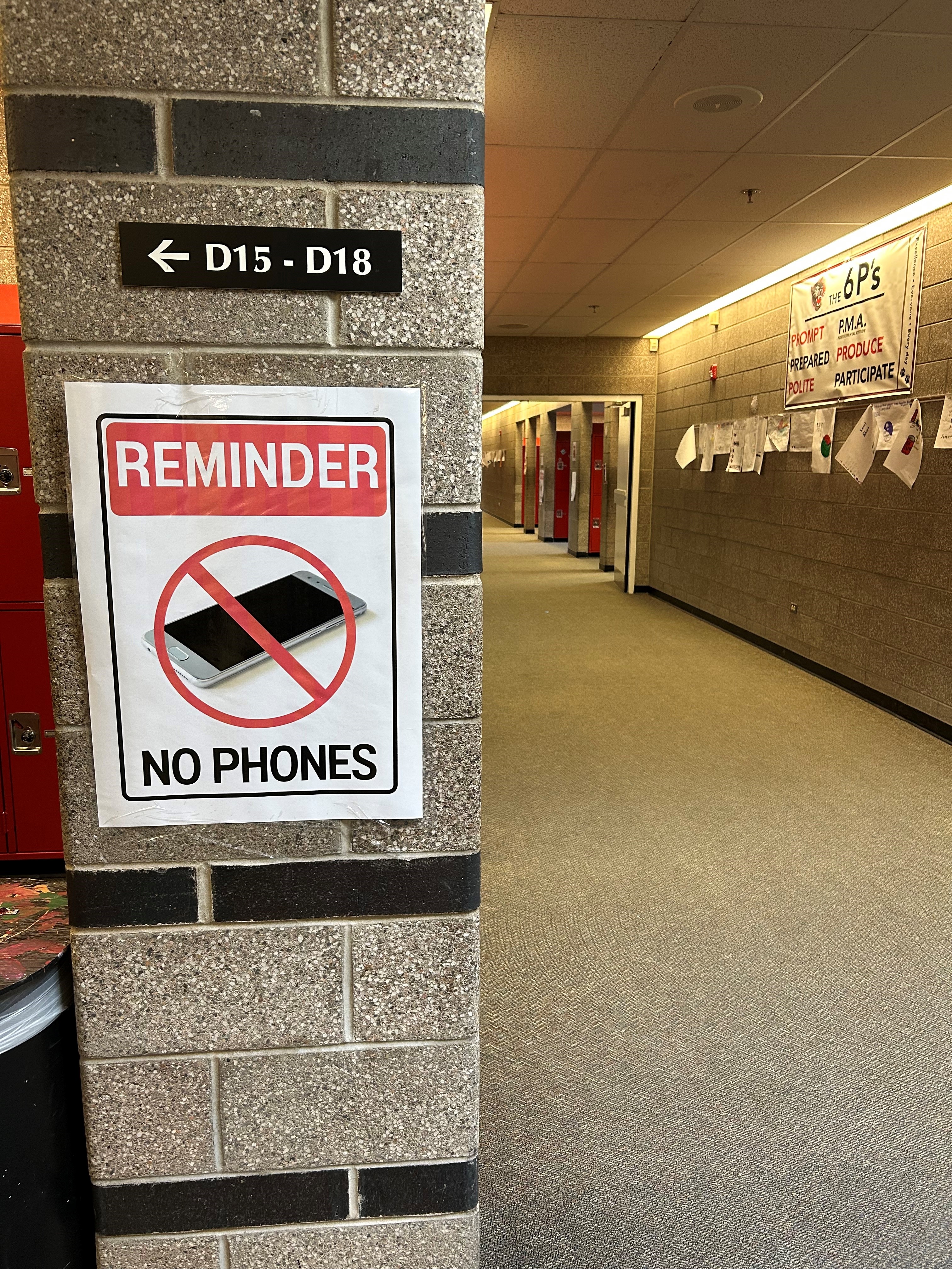 A poster reminding kids not to use cell phones.