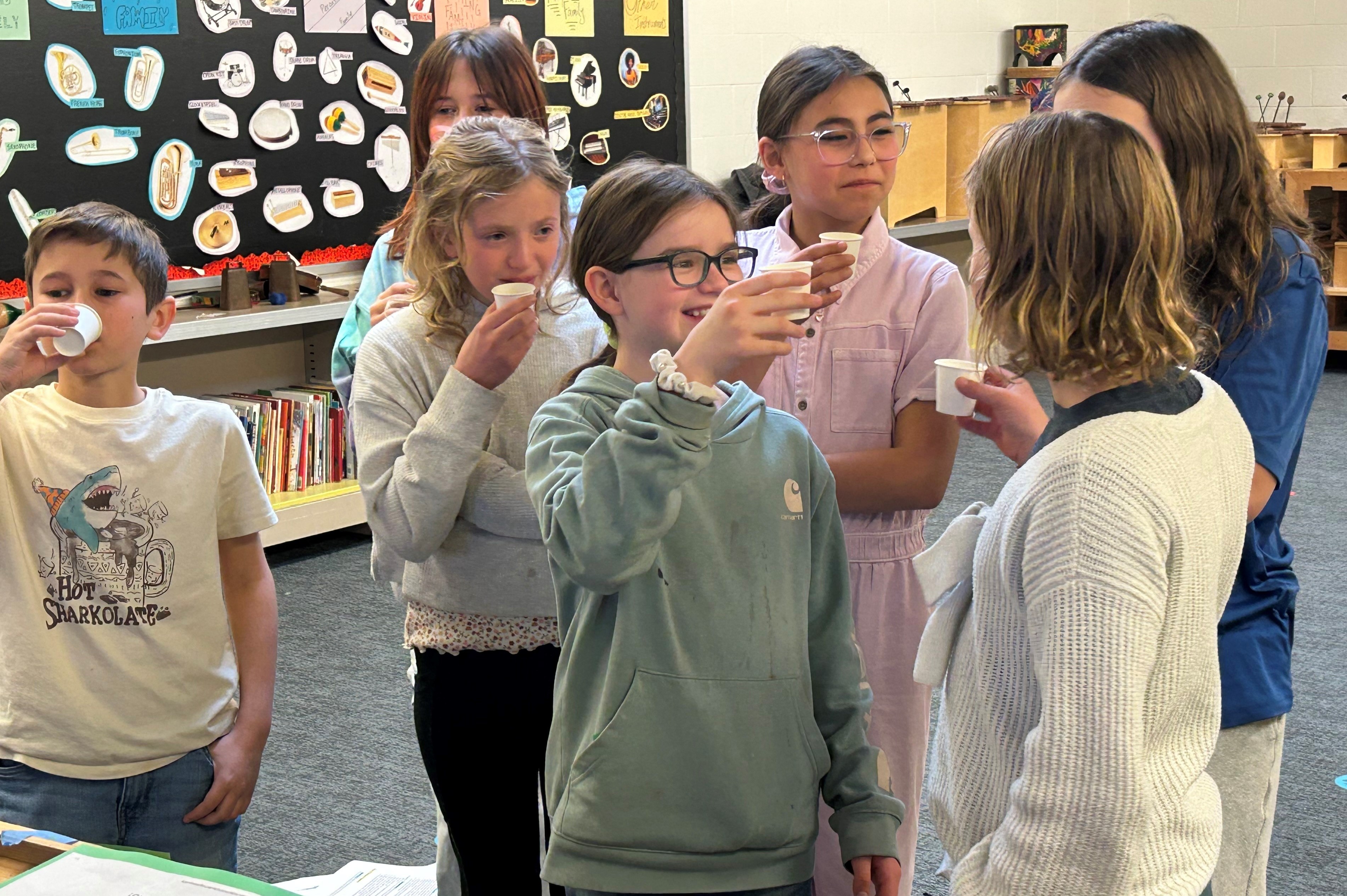 Students perform a closing toast.