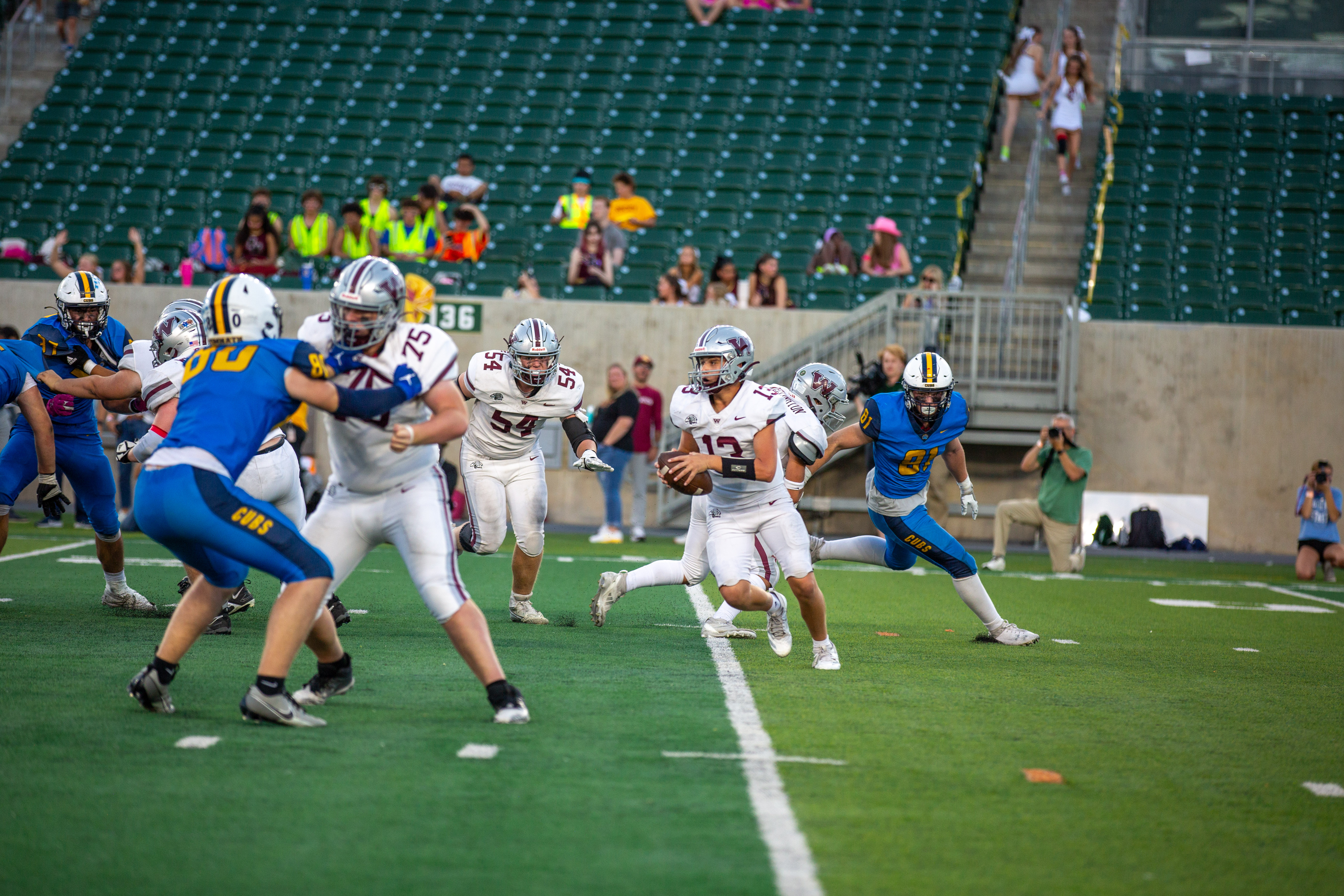 A Wellington Middle-High School football player has the ball. 