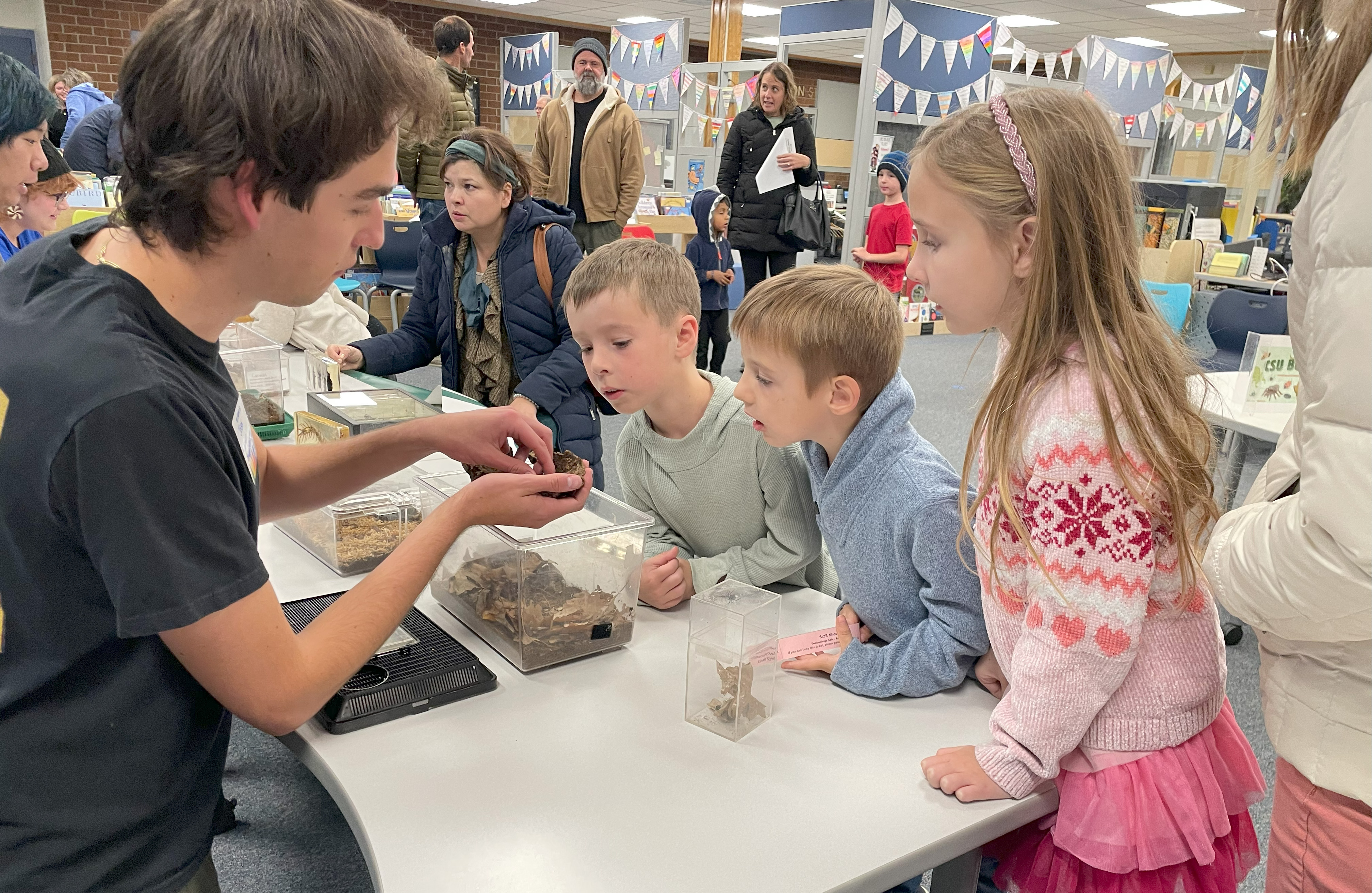 Students examine bugs at Shepardson STEM Night.