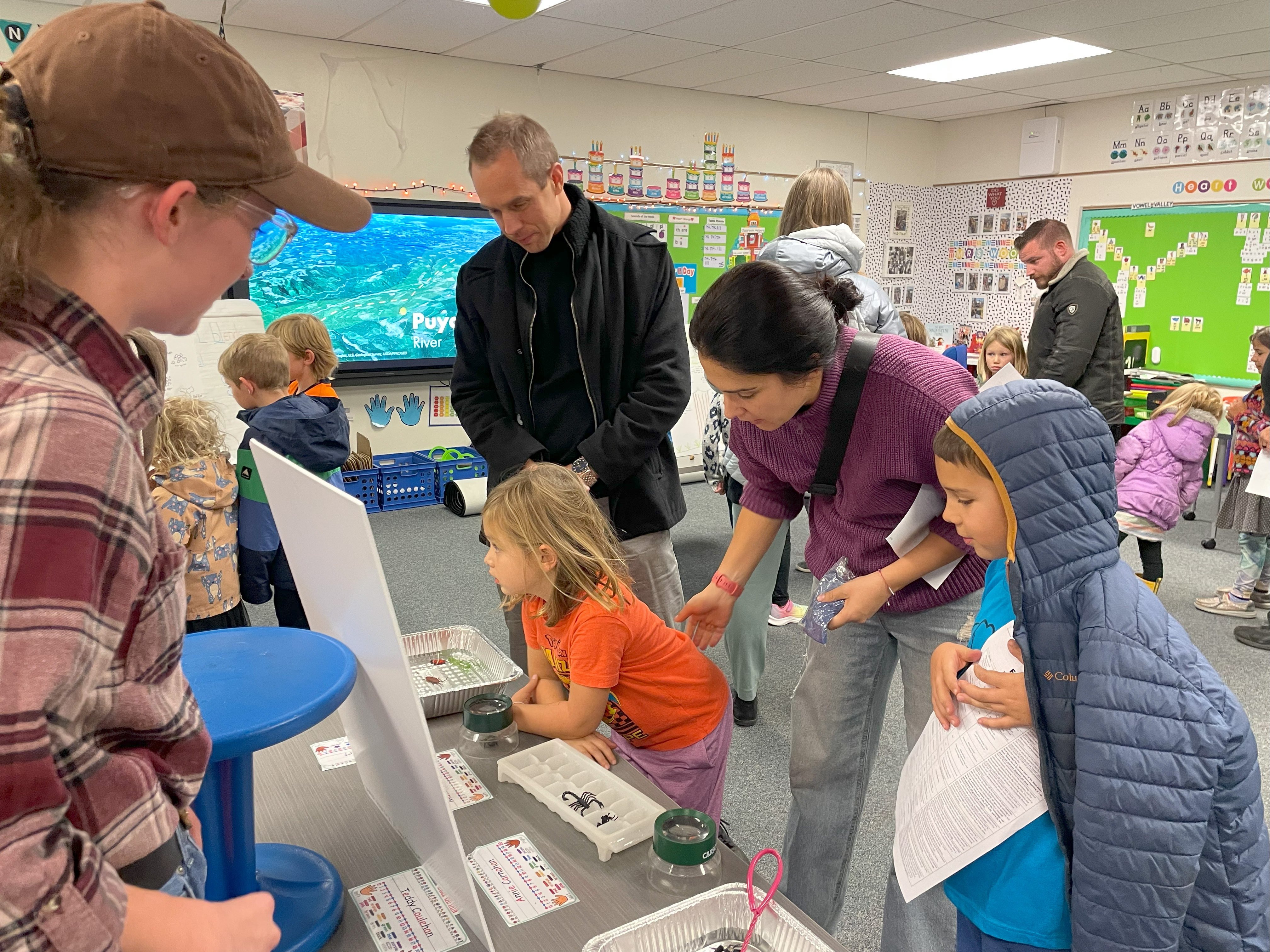 A family checks out a presentation at Shepardson STEM Night. 