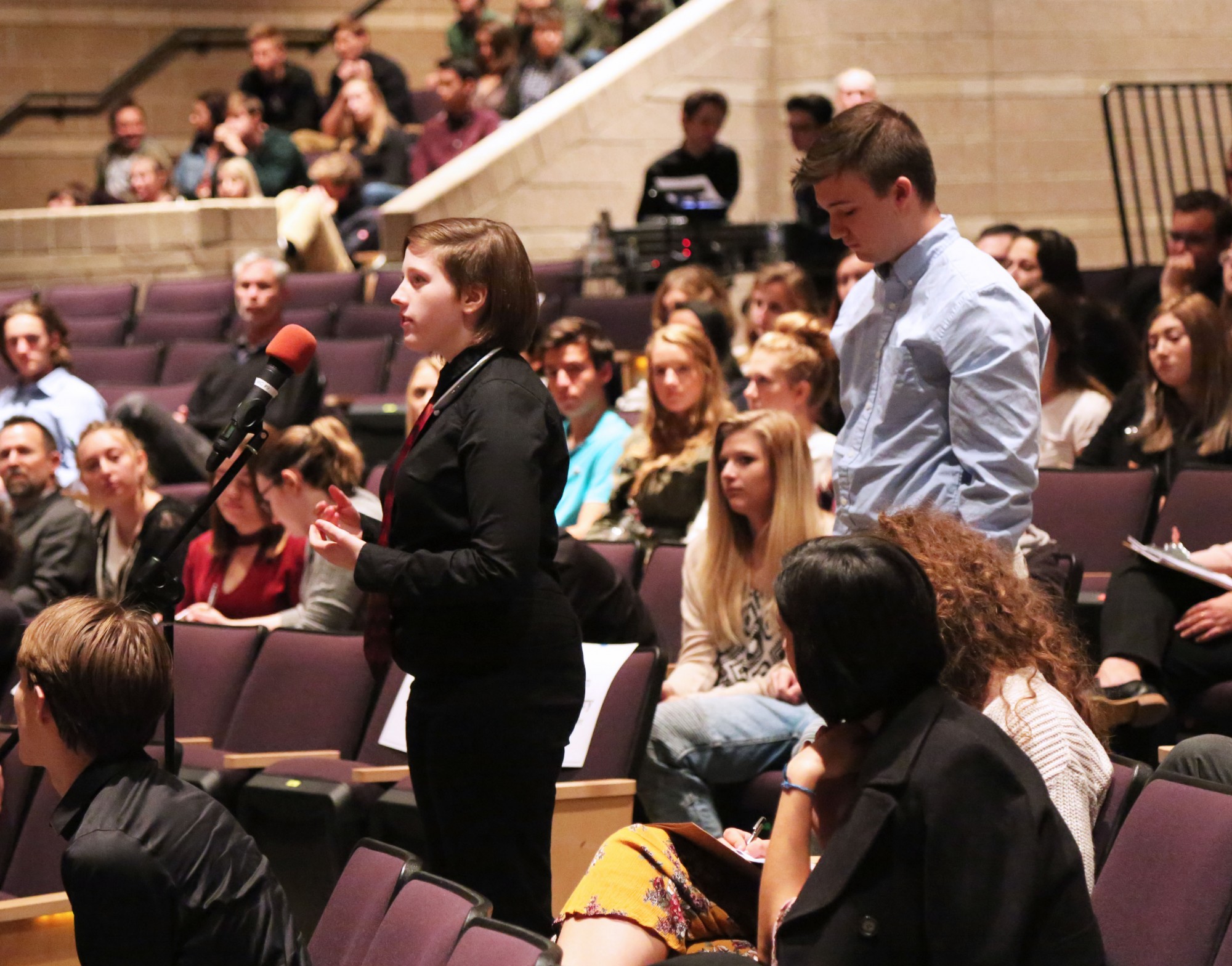 Two Fossil Ridge students stand at the microphone to ask the Colorado Supreme Court justices questions.