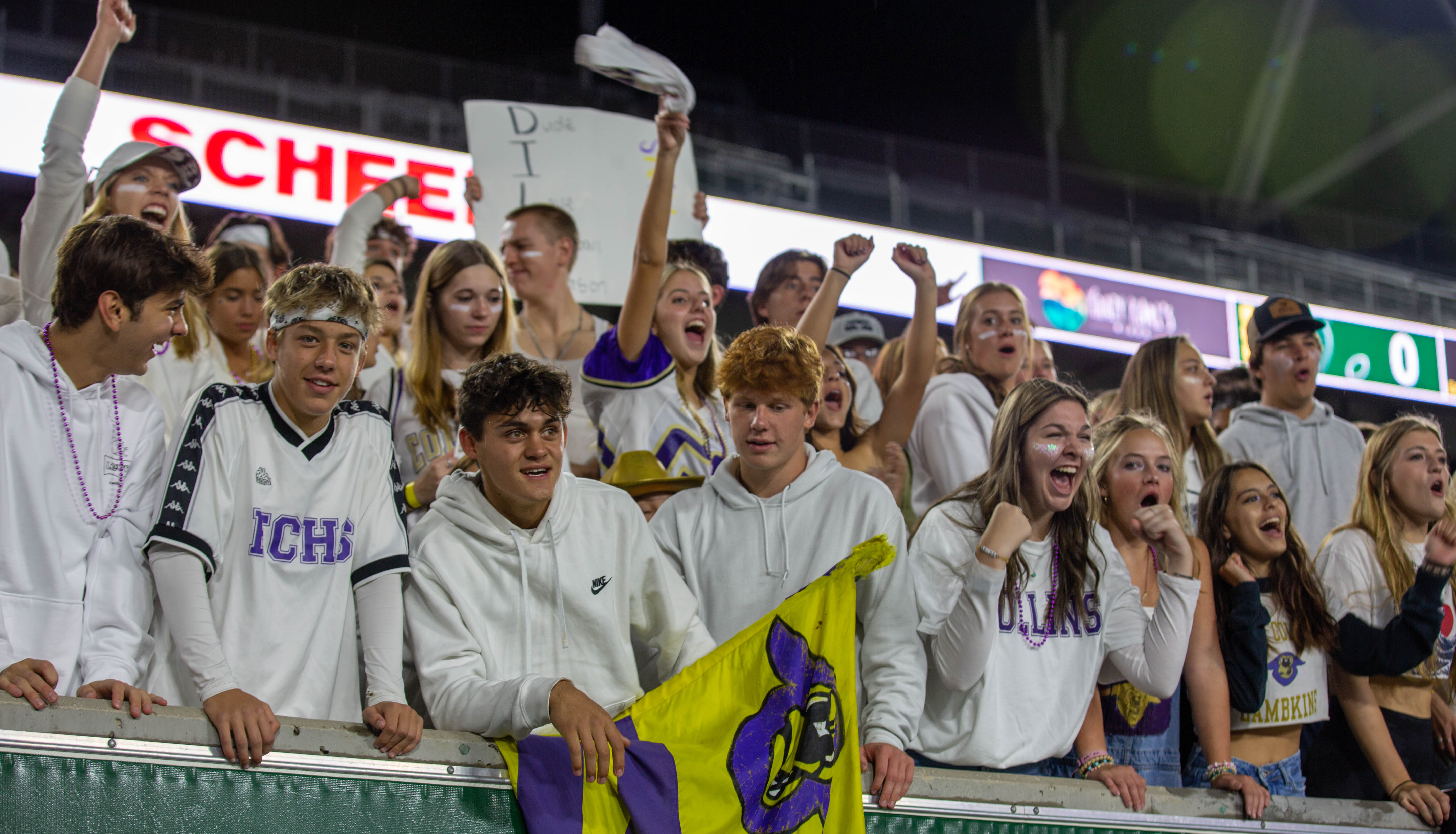 Students cheering at the Canvas Community Classic football game.