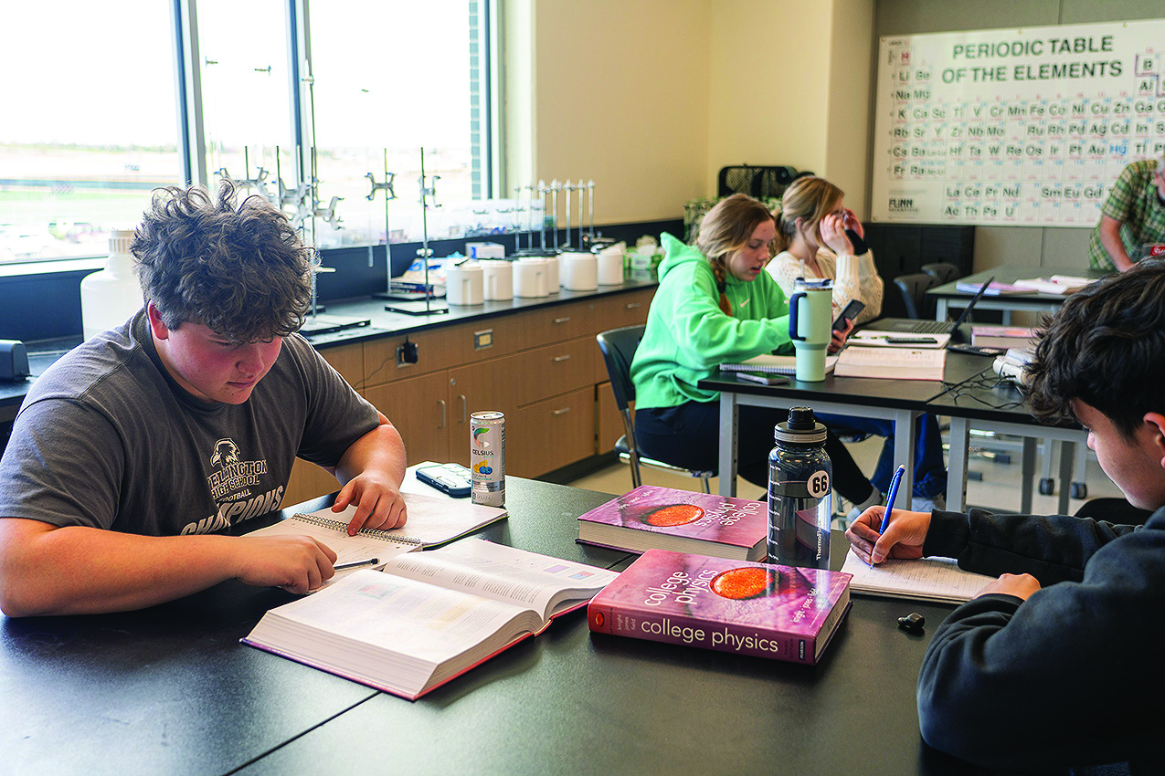 High school students working at classroom desks. 