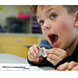 A young boy has an aha moment while studying worms.