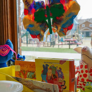 A kindergarten classroom with tissue paper decorating the window.