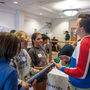 A NASA professional talks with students at the career fair.