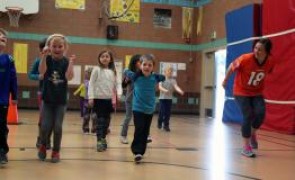 Kids playing in a school gymnasium